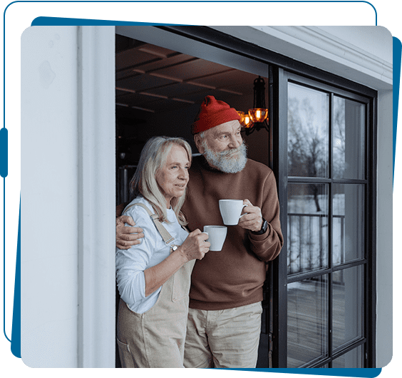 A man and woman holding coffee cups in their hands.