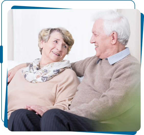 A man and woman sitting on the couch together.